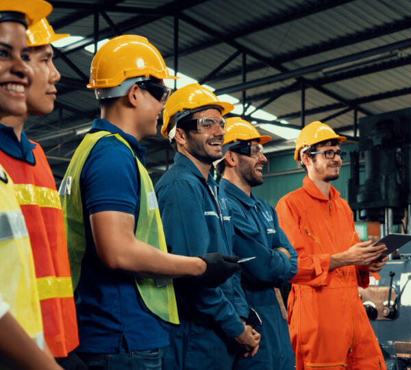 Skillful worker attending brief meeting in the factory . Industrial people and manufacturing labor concept .